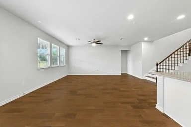 17320 Calipatria Ln, Pflugerville, TX 78660 - unfurnished living room with ceiling fan, recessed lighting, stairway, and wood finished floors
