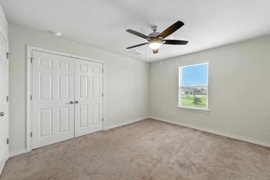 17320 Calipatria Ln, Pflugerville, TX 78660 - unfurnished bedroom with a closet, carpet, and a ceiling fan