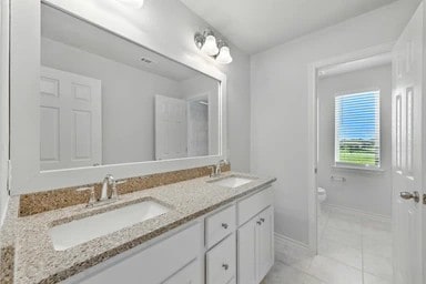 17320 Calipatria Ln, Pflugerville, TX 78660 - full bathroom featuring double vanity and tile patterned flooring