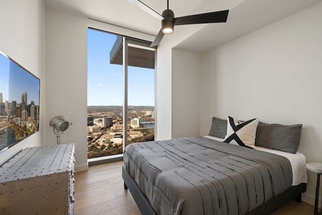 44 E Ave Unit 3801, Austin, TX 78701 - bedroom featuring light wood-style flooring and a ceiling fan