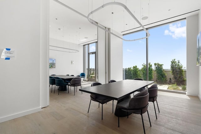 44 E Ave Unit 3801, Austin, TX 78701 - dining room with expansive windows, healthy amount of natural light, and light wood finished floors