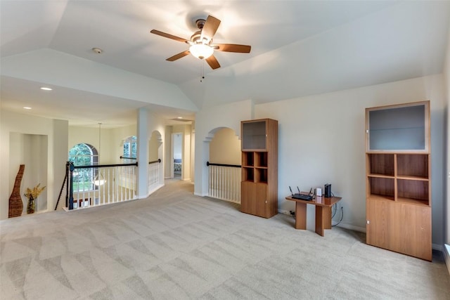 12816 Texas Sage Ct, Austin, TX 78732 - spare room featuring a ceiling fan, lofted ceiling, carpet floors, and arched walkways