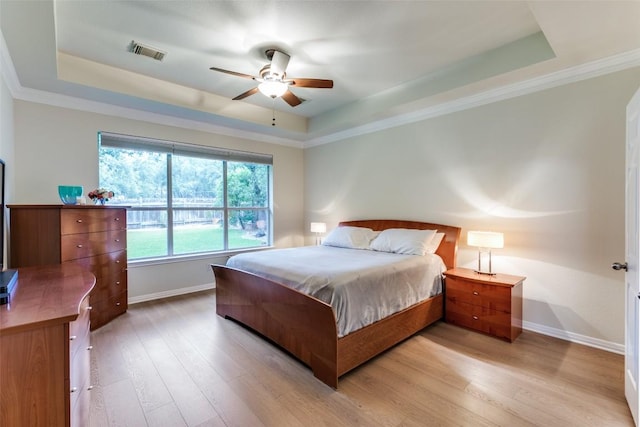 12816 Texas Sage Ct, Austin, TX 78732 - bedroom featuring a raised ceiling and light wood finished floors