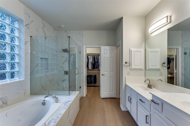 12816 Texas Sage Ct, Austin, TX 78732 - bathroom with double vanity, plenty of natural light, a whirlpool tub, and wood finished floors