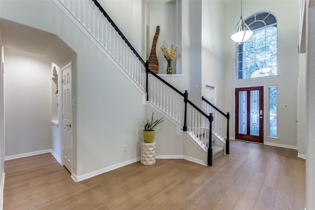 12816 Texas Sage Ct, Austin, TX 78732 - foyer with a towering ceiling, stairway, and wood finished floors