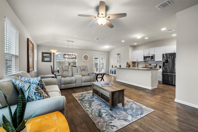 118 Craft St, Hutto, TX 78634 - living area with dark wood finished floors, ceiling fan, recessed lighting, and a chandelier