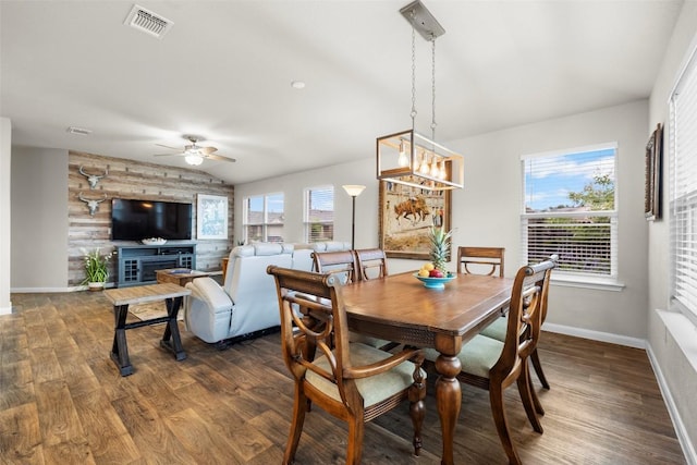 118 Craft St, Hutto, TX 78634 - dining room with ceiling fan, dark wood-style flooring, lofted ceiling, and a chandelier