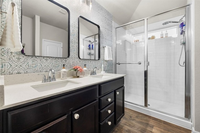 118 Craft St, Hutto, TX 78634 - bathroom featuring lofted ceiling, wood finished floors, double vanity, and a stall shower