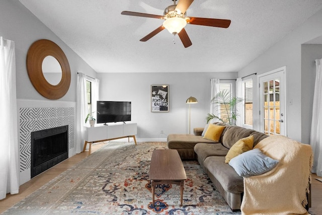 8406 Copano Dr, Austin, TX 78749 - living area featuring plenty of natural light, ceiling fan, a tile fireplace, and a textured ceiling