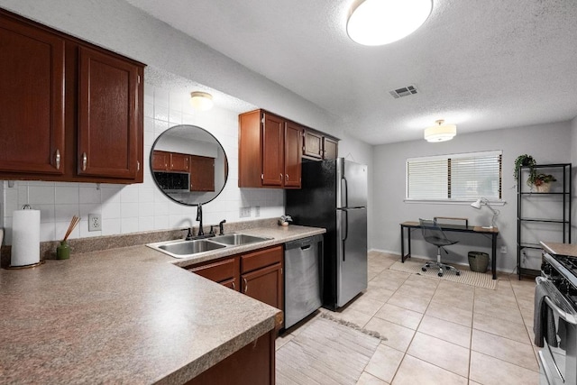 8406 Copano Dr, Austin, TX 78749 - kitchen with appliances with stainless steel finishes, backsplash, a textured ceiling, an office area, and light tile patterned flooring