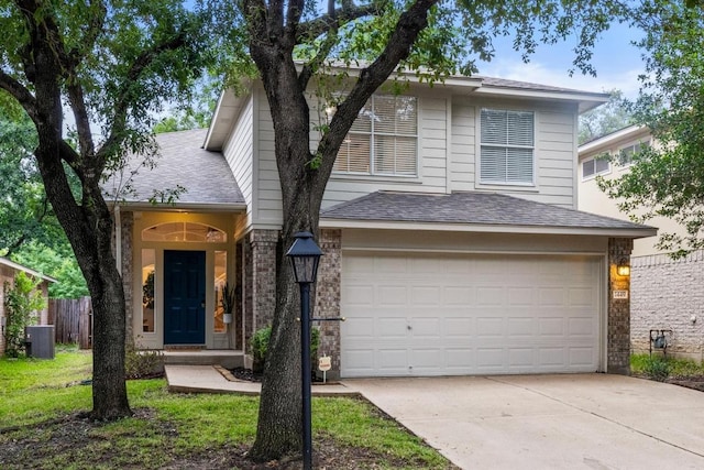 1449 Sir Thopas Trl, Austin, TX 78748 - traditional-style house with an attached garage, driveway, roof with shingles, and brick siding