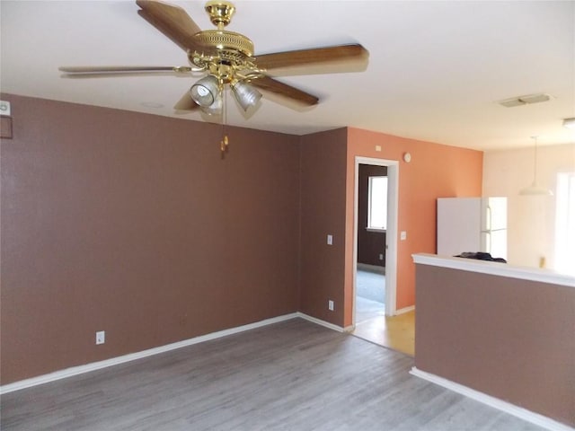 15110 Chamberlain Ct, Austin, TX 78724 - unfurnished living room featuring wood finished floors, ceiling fan, and healthy amount of natural light