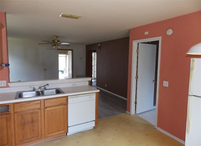 15110 Chamberlain Ct, Austin, TX 78724 - kitchen featuring white appliances, a peninsula, light countertops, a ceiling fan, and brown cabinetry