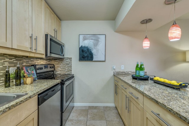 7685 Northcross Dr Unit 907, Austin, TX 78757 - kitchen with appliances with stainless steel finishes, light brown cabinetry, tasteful backsplash, pendant lighting, and light stone counters