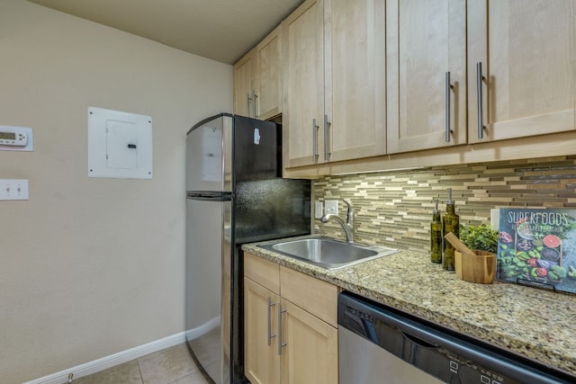 7685 Northcross Dr Unit 907, Austin, TX 78757 - kitchen featuring appliances with stainless steel finishes, light brown cabinets, electric panel, backsplash, and light tile patterned floors