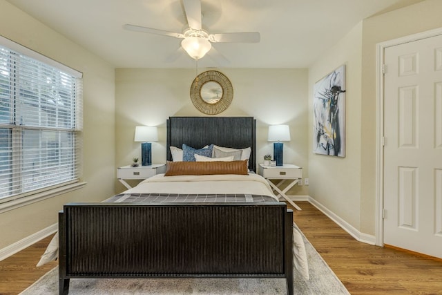 7685 Northcross Dr Unit 907, Austin, TX 78757 - bedroom with wood finished floors and ceiling fan