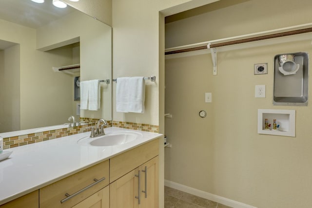 7685 Northcross Dr Unit 907, Austin, TX 78757 - bathroom featuring vanity, backsplash, and tile patterned floors