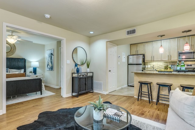 7685 Northcross Dr Unit 907, Austin, TX 78757 - living room featuring light wood finished floors and ceiling fan