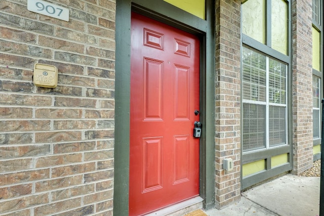 7685 Northcross Dr Unit 907, Austin, TX 78757 - doorway to property featuring brick siding