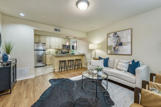 7685 Northcross Dr Unit 907, Austin, TX 78757 - living area with light wood-style flooring and baseboards