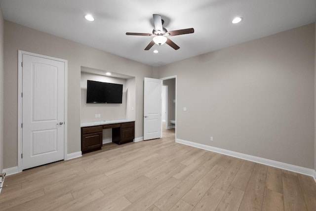 136 Firefall Ln, Austin, TX 78737 - unfurnished bedroom with light wood-style flooring, built in desk, recessed lighting, and a ceiling fan