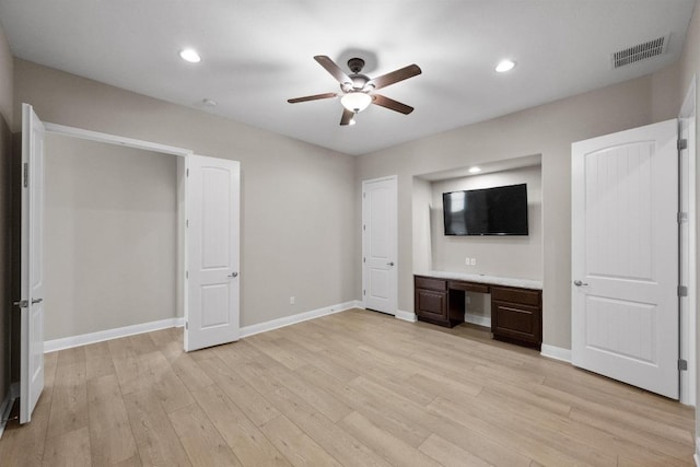 136 Firefall Ln, Austin, TX 78737 - unfurnished bedroom featuring built in study area, light wood-type flooring, recessed lighting, and ceiling fan