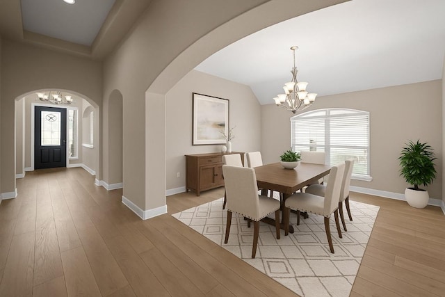 136 Firefall Ln, Austin, TX 78737 - dining room with a chandelier, arched walkways, light wood finished floors, and lofted ceiling