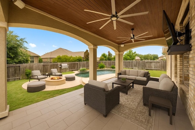 136 Firefall Ln, Austin, TX 78737 - fenced backyard featuring a patio area, area for grilling, an outdoor living space with a fire pit, and a ceiling fan