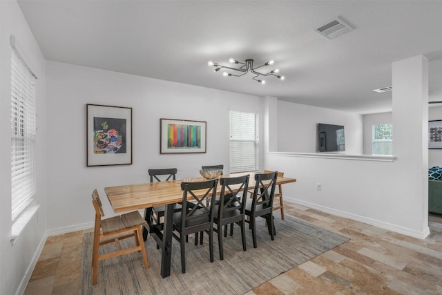 1509 Strickland Dr, Austin, TX 78748 - dining area featuring a chandelier and stone finish flooring