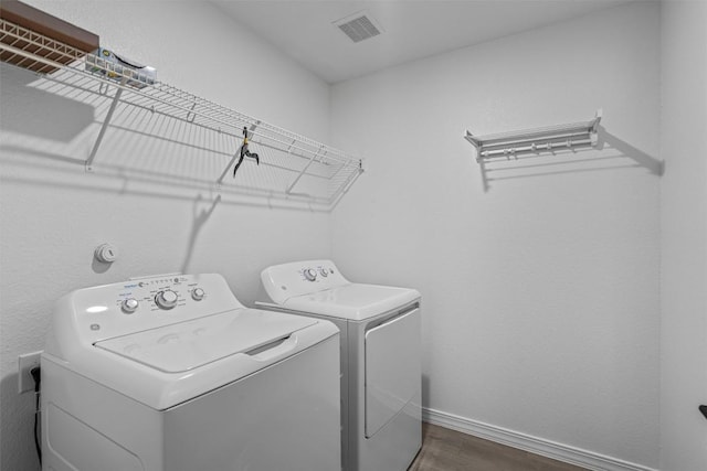1509 Strickland Dr, Austin, TX 78748 - laundry room featuring washing machine and clothes dryer and dark wood-type flooring