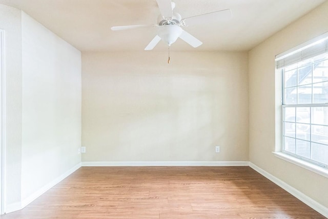 7685 Northcross Dr Unit 901, Austin, TX 78757 - empty room featuring light wood-type flooring, healthy amount of natural light, and a ceiling fan