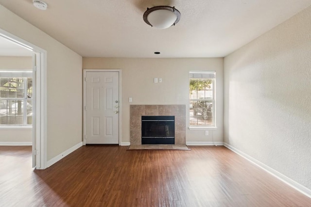 7685 Northcross Dr Unit 901, Austin, TX 78757 - unfurnished living room with wood finished floors and a fireplace