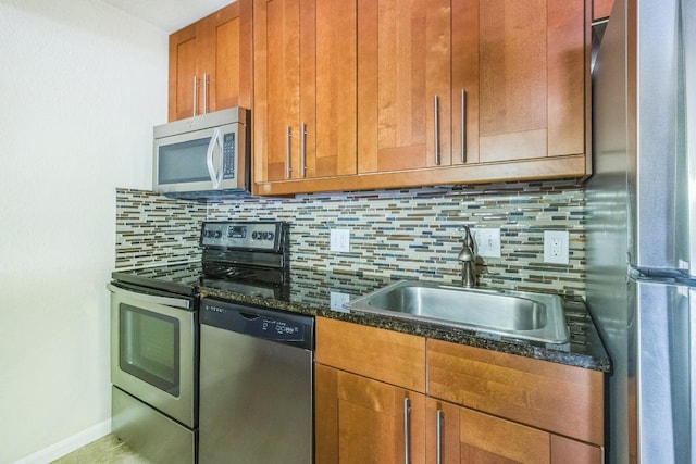 7685 Northcross Dr Unit 901, Austin, TX 78757 - kitchen featuring stainless steel appliances, decorative backsplash, dark stone counters, and brown cabinets