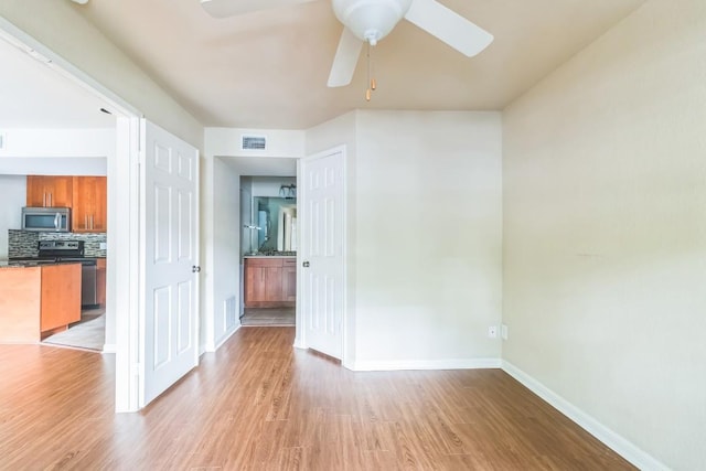 7685 Northcross Dr Unit 901, Austin, TX 78757 - spare room featuring a ceiling fan and light wood-type flooring