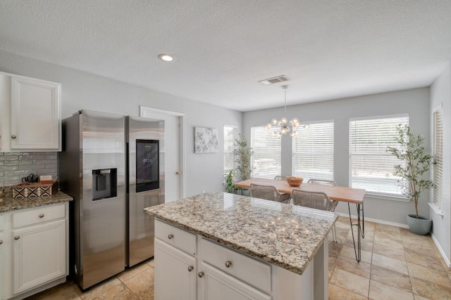 1511 Rhapsody Ridge Dr, Cedar Park, TX 78613 - kitchen featuring stainless steel fridge, a chandelier, plenty of natural light, a kitchen island, and recessed lighting