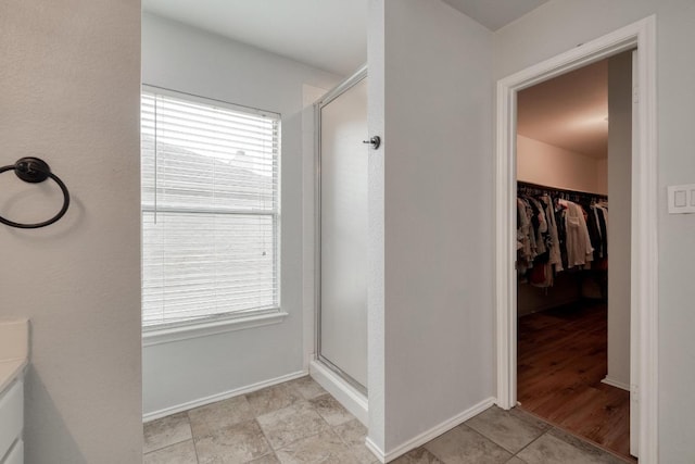 1511 Rhapsody Ridge Dr, Cedar Park, TX 78613 - full bathroom featuring a shower stall, healthy amount of natural light, a spacious closet, and tile patterned flooring