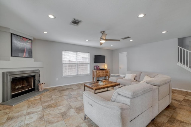 1511 Rhapsody Ridge Dr, Cedar Park, TX 78613 - living room featuring recessed lighting, a fireplace with raised hearth, ceiling fan, stone finish floors, and stairs