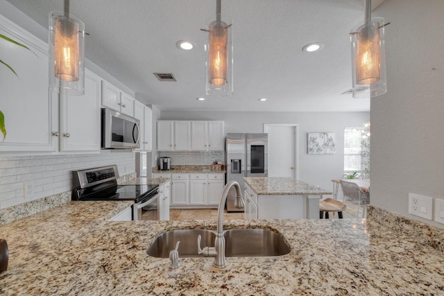 1511 Rhapsody Ridge Dr, Cedar Park, TX 78613 - kitchen with stainless steel appliances, light stone countertops, tasteful backsplash, white cabinetry, and recessed lighting