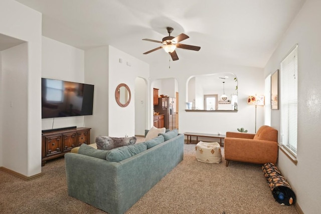 11012 Short Springs Dr, Austin, TX 78754 - living area featuring dark colored carpet, ceiling fan, arched walkways, and vaulted ceiling
