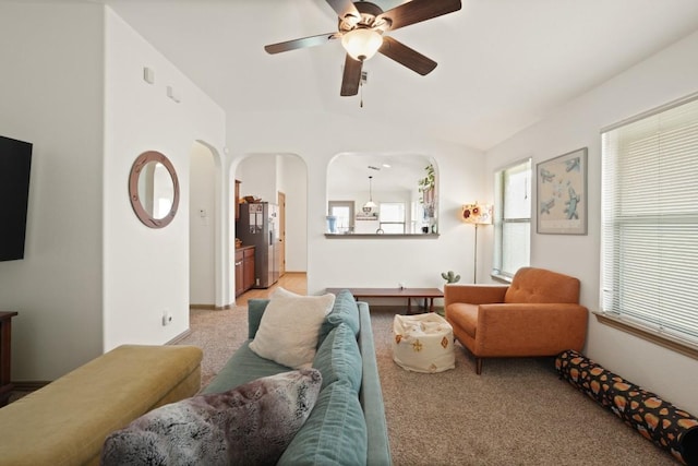 11012 Short Springs Dr, Austin, TX 78754 - living room with a ceiling fan, light colored carpet, arched walkways, and lofted ceiling