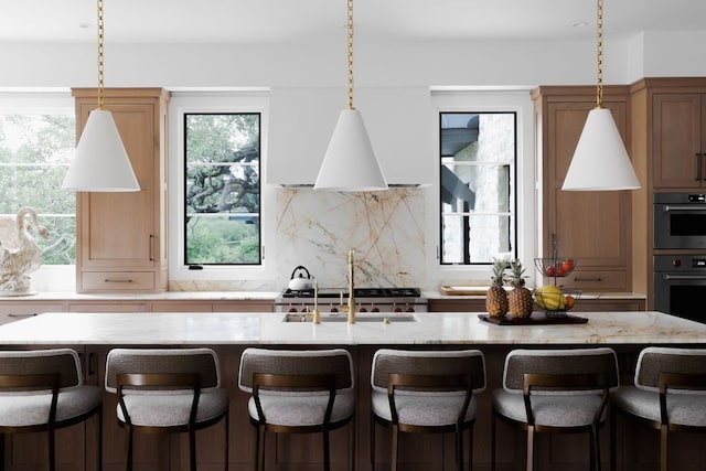 4100 Mcbrine Pl, Austin, TX 78746 - kitchen featuring decorative backsplash, hanging light fixtures, and plenty of natural light