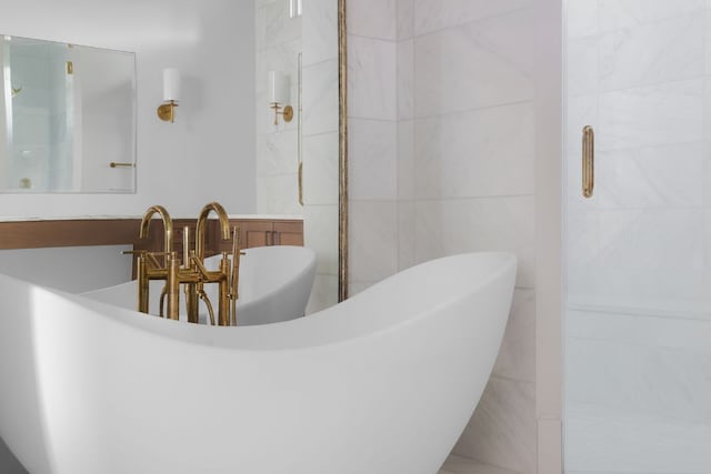 4100 Mcbrine Pl, Austin, TX 78746 - full bathroom with tile walls, a soaking tub, and a shower with door
