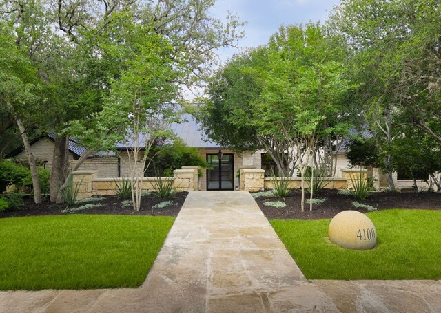 4100 Mcbrine Pl, Austin, TX 78746 - view of front of house featuring stone siding and a front lawn