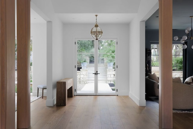 4100 Mcbrine Pl, Austin, TX 78746 - doorway featuring hardwood / wood-style flooring, a chandelier, and french doors