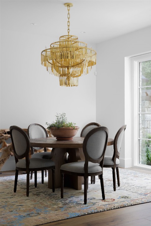 4100 Mcbrine Pl, Austin, TX 78746 - dining area featuring a chandelier, plenty of natural light, and wood finished floors