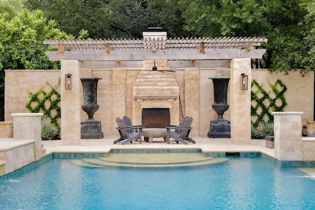 4100 Mcbrine Pl, Austin, TX 78746 - outdoor pool featuring an outdoor stone fireplace and a patio area