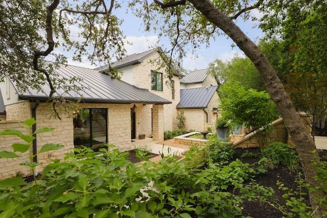 4100 Mcbrine Pl, Austin, TX 78746 - rear view of house featuring a standing seam roof, a metal roof, and stone siding
