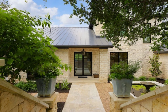 4100 Mcbrine Pl, Austin, TX 78746 - view of exterior entry featuring a standing seam roof, a metal roof, and stone siding