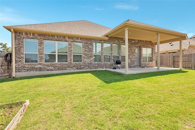 817 Clear Spring Ln, Leander, TX 78641 - back of property featuring brick siding, a patio, and roof with shingles