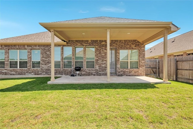 817 Clear Spring Ln, Leander, TX 78641 - back of property featuring brick siding, a patio, and roof with shingles